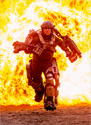 Illustration for article titled Here's a photo of Tom Cruise wearing armor and ridding himself of aliens that is not a metaphor for anything